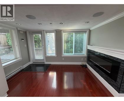 A living room with a fireplace and hardwood floors.