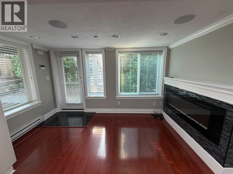 A living room with a fireplace and hardwood floors.