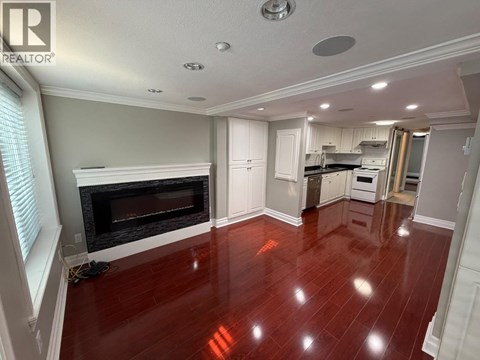 A living room with a fireplace and hardwood floors.