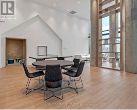 A dining room with a table and chairs.