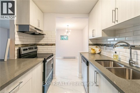 A modern kitchen with white cabinets and stainless steel appliances.