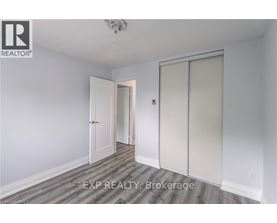 A room with a sliding door and a ceiling fan.