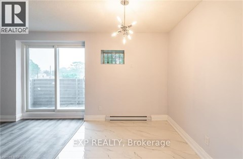 A room with EXP REALTY, Brokerage logo on the wall.