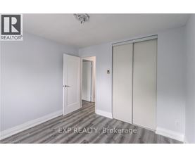 A room with a sliding door and a ceiling fan.