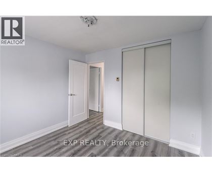 A room with a sliding door and a ceiling fan.