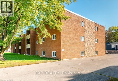 A brick building with trees in front of it.