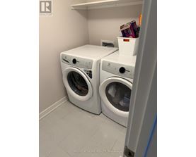 Two front loading washing machines in a laundry room.