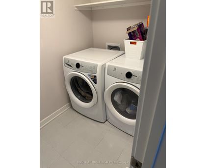Two front loading washing machines in a laundry room.