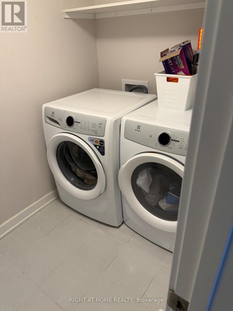 Two front loading washing machines in a laundry room.