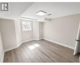 A room with a window and a door is for rent.