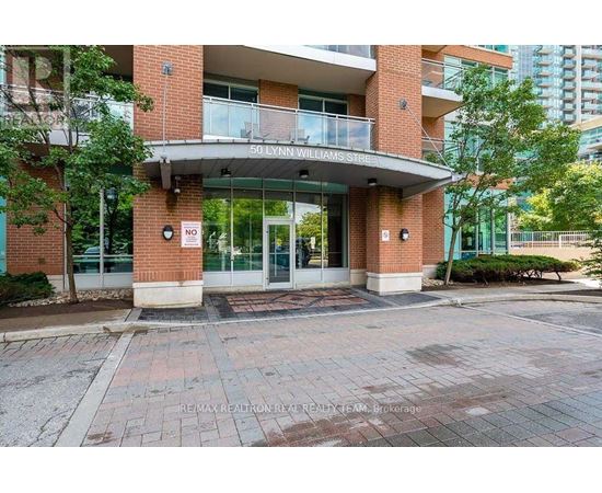 The entrance to a building with a glass door and a sign that says "No Parking".