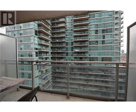 A glass building with a balcony in front of it.