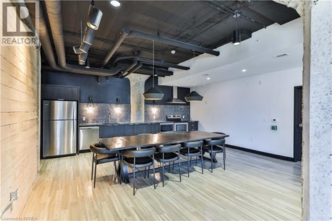 A modern kitchen with a dining table and chairs.