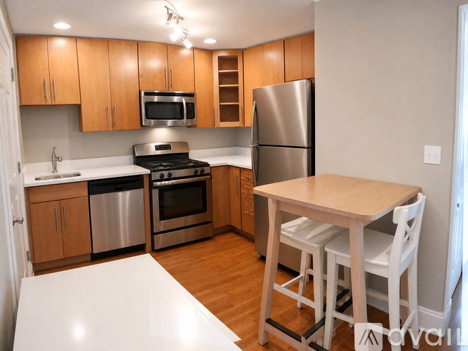 A kitchen with wooden cabinets and stainless steel appliances.