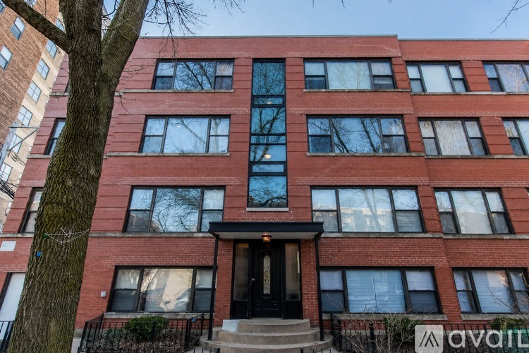 A red brick building with a black door and windows.