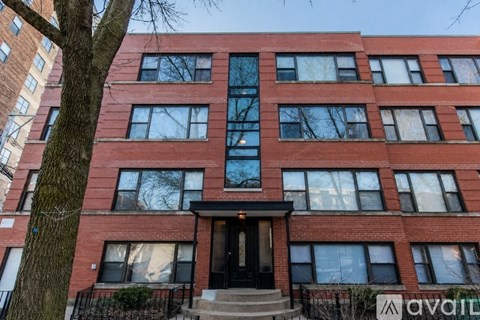 A red brick building with a black door and windows.