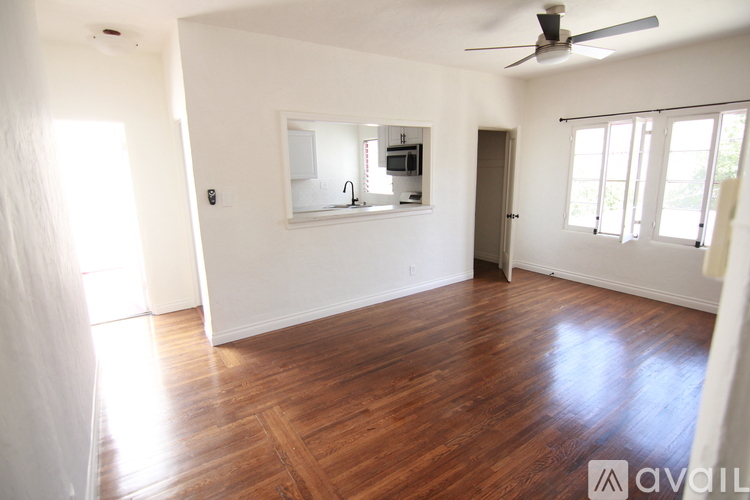 A room with wooden floors and a ceiling fan.