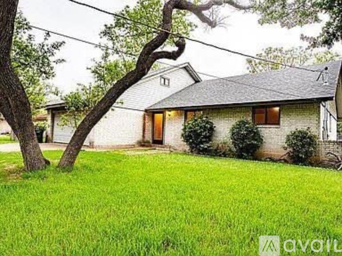 A house with a tree in front of it.
