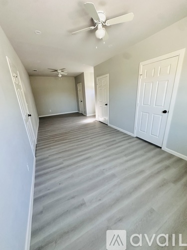 A room with a ceiling fan and lighting fixtures.