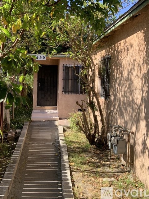 A house numbered 455 is shown with a tree in front of it.