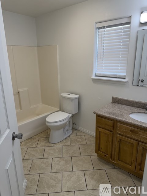 A bathroom with a toilet, sink, and bathtub.