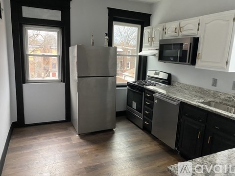 A kitchen with a refrigerator, stove, and oven.
