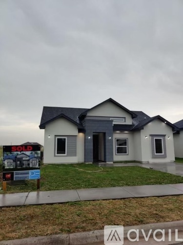 A house with a sold sign in front of it.