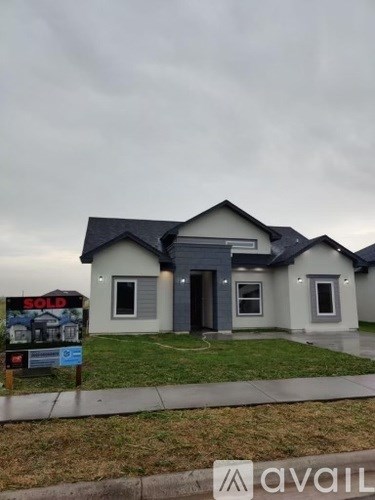 A house with a sold sign in front of it.