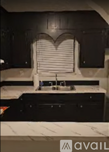 A kitchen with a sink and a counter.