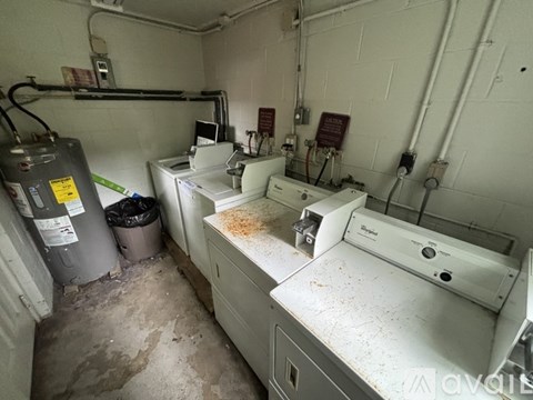 A dirty bathroom with a toilet and a sink.