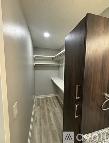 A hallway with a wooden door on the right.