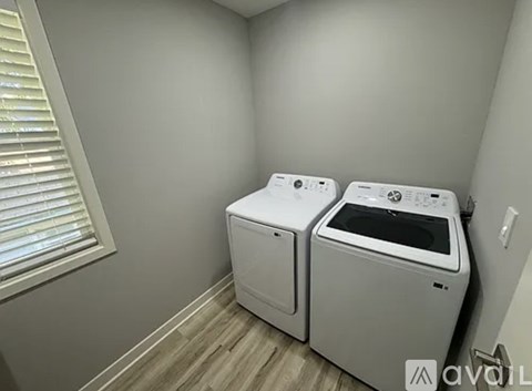 Two front loading washing machines in a laundry room.