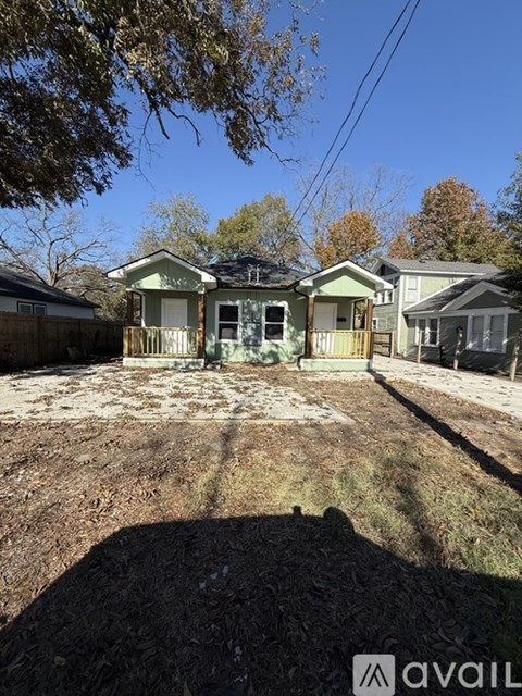 A house with a green front yard is for sale.