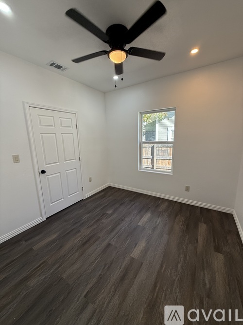 A room with a ceiling fan and a window.