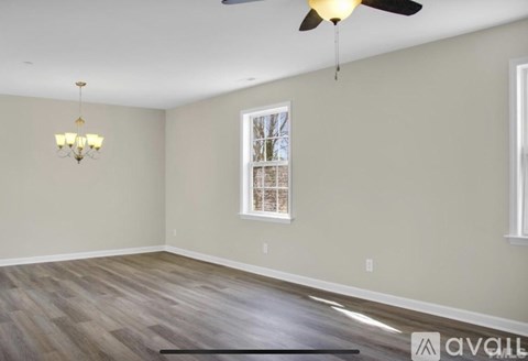 A room with a ceiling fan and a chandelier.