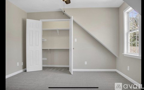 A room with a white door and a window.