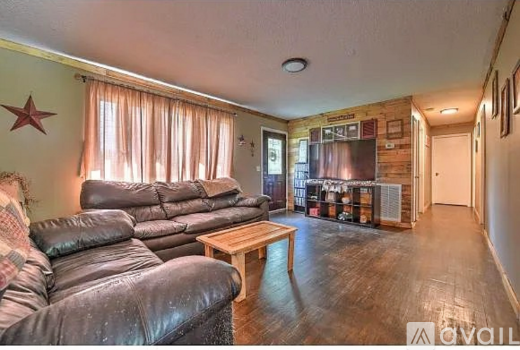 A living room with a leather sofa and a wooden coffee table.