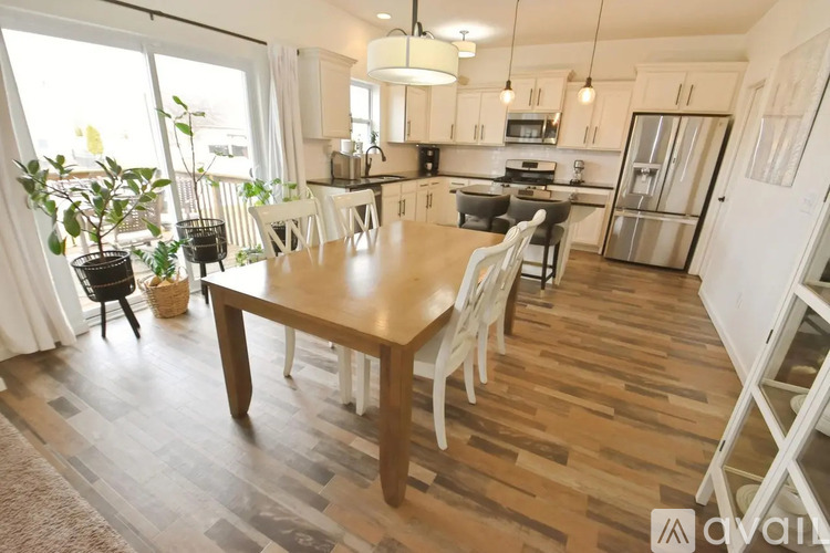 A kitchen with a table and chairs in the middle of the room.