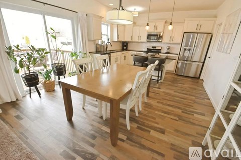 A kitchen with a table and chairs in the middle of the room.