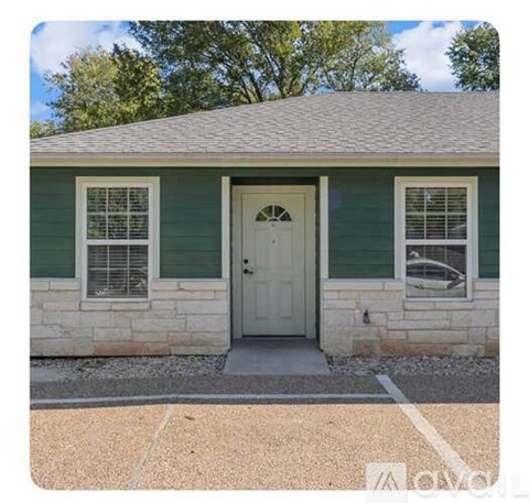 A small house with a white door and windows.