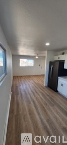 A room with wooden flooring and a white ceiling.