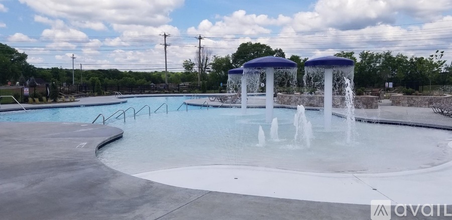 A pool with a fountain in the middle of it.