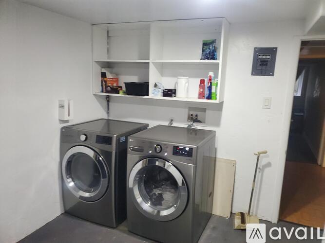 Two front loading washing machines in a laundry room.