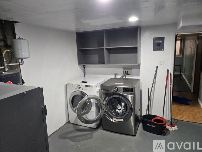 A white bathroom with a shower and a toilet.