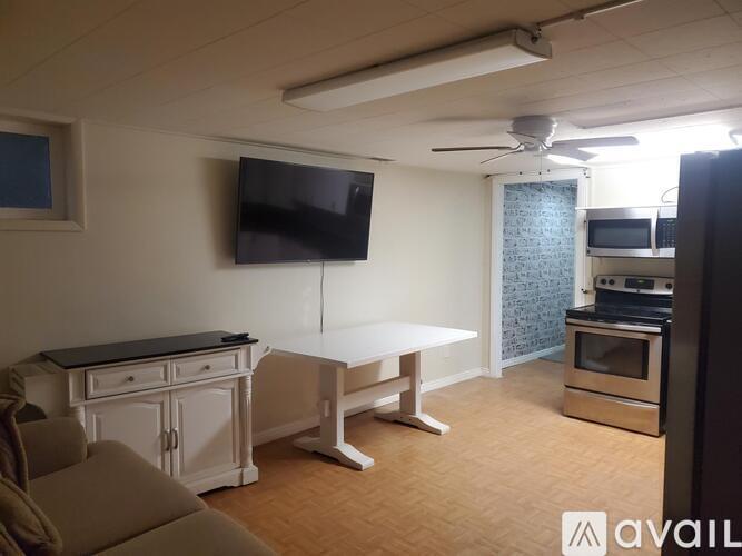 A living room with a television, a table, and a couch.