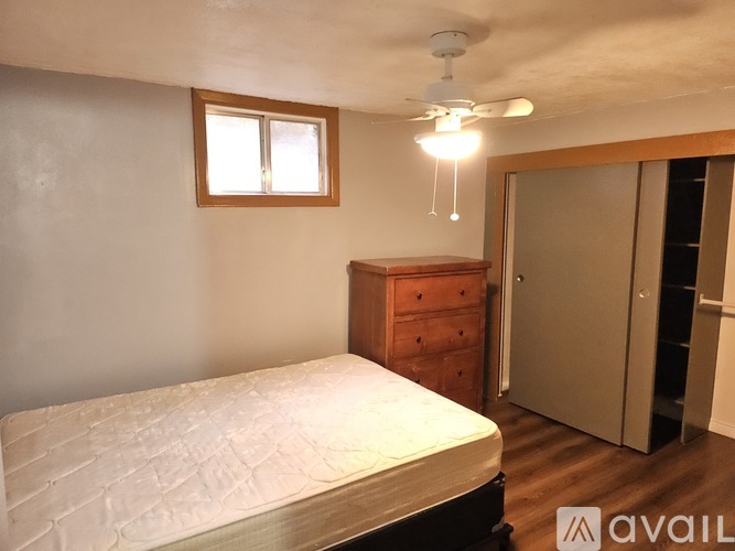A kitchen with white cabinets and a stainless steel refrigerator.