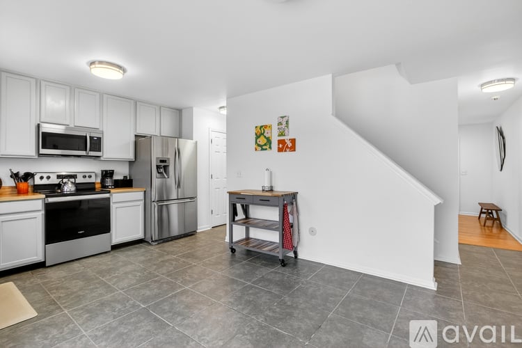 A kitchen with white cabinets and stainless steel appliances.