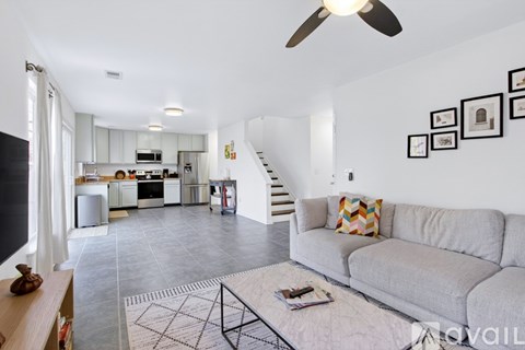A living room with a grey couch and a coffee table in front of it.