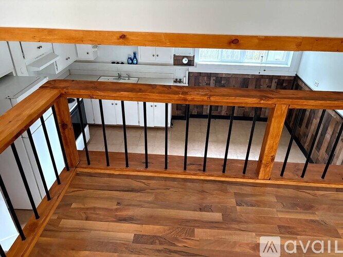 A wooden staircase with a metal railing.