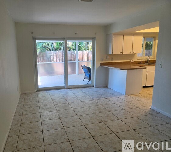A kitchen area with a counter and a chair.